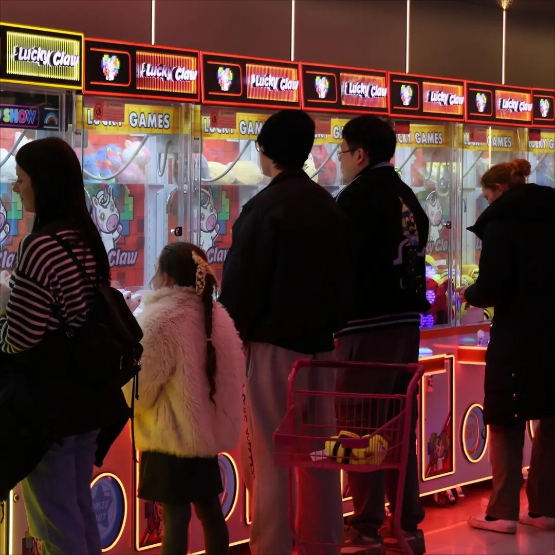 A group playing the claw machines at Lucky Claw Birmingham