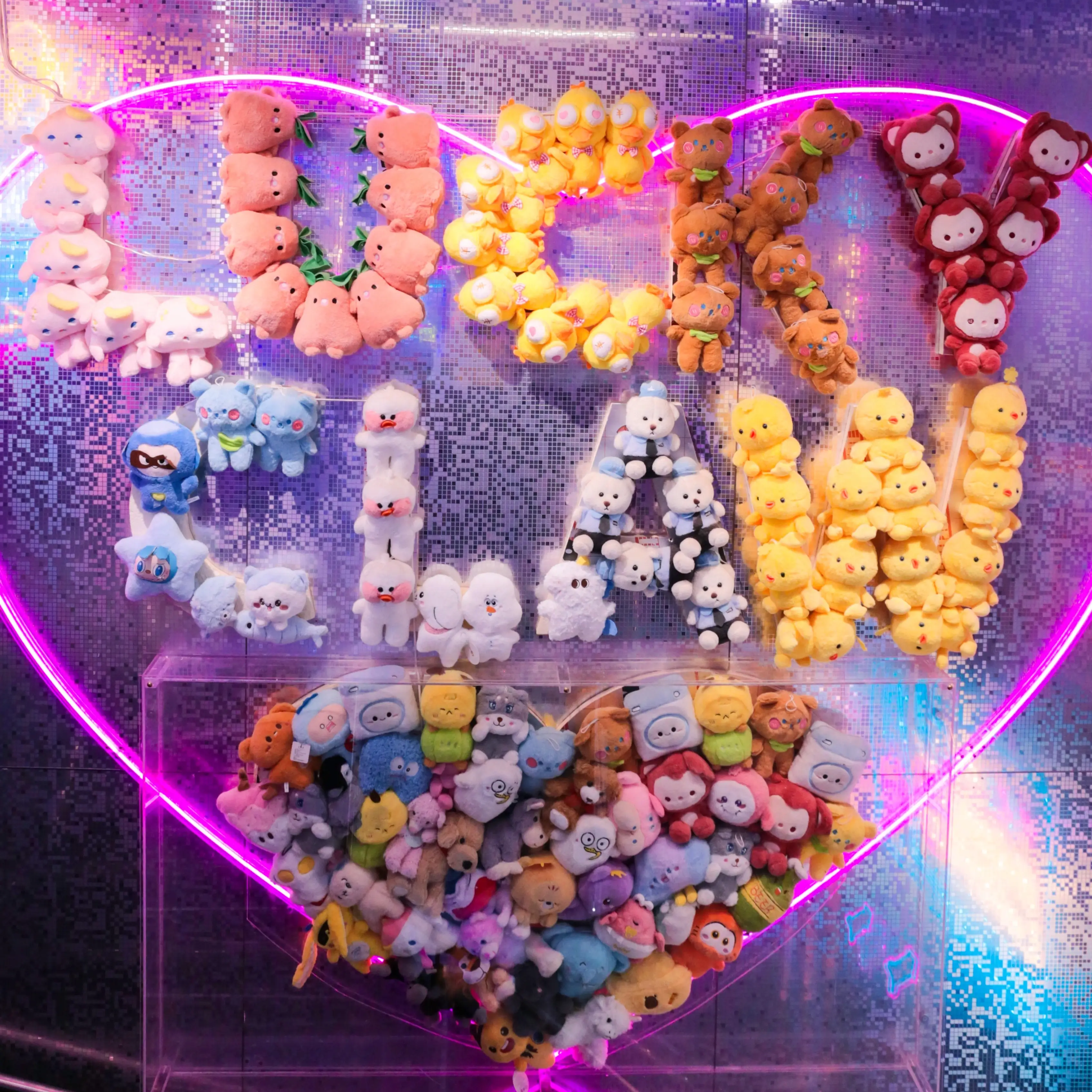 A neon heart filled with plushies spelling Lucky Claw